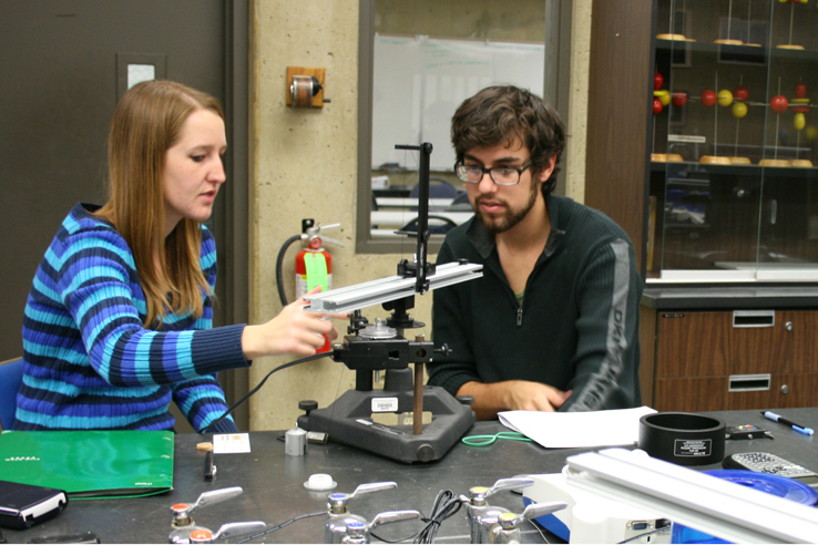 Students working with a machine in a lab